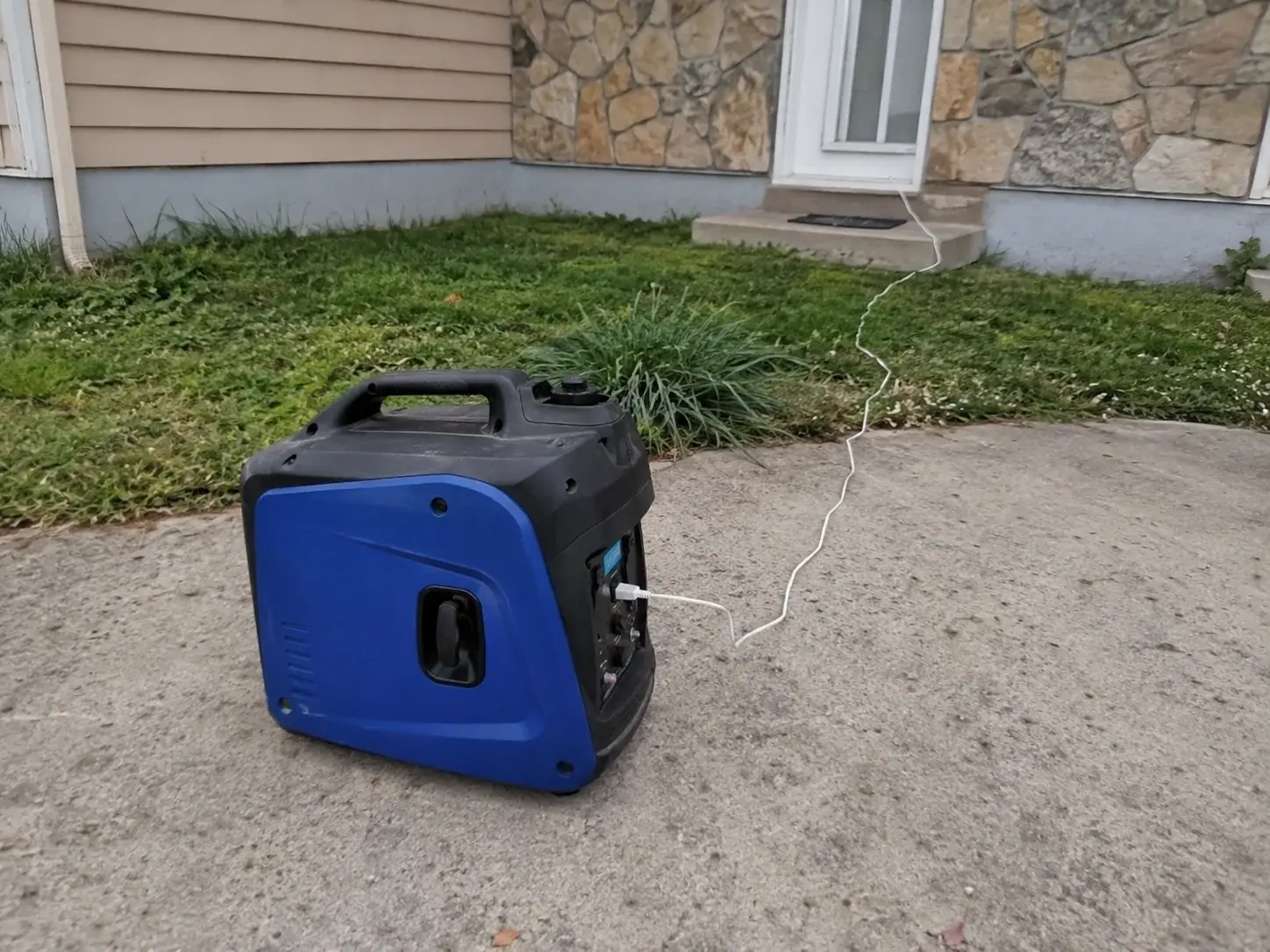 Prenosni inverter generator na betonskoj površini u dvorištu kuće