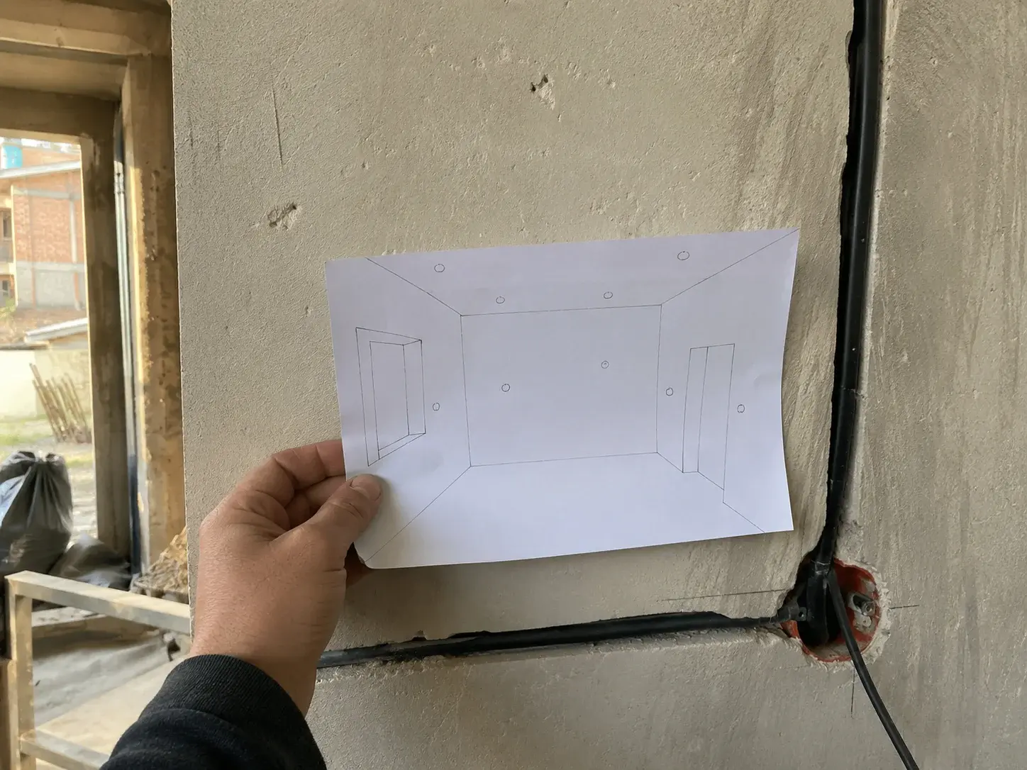Skica rasporeda tačaka naslonjena na nedovršen zid